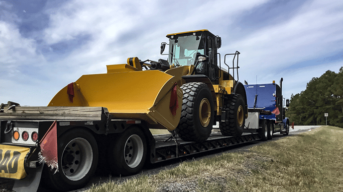 Backhoe on lowboy trailer